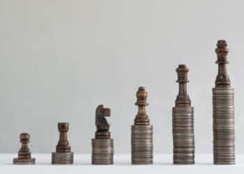 Image of chess pieces on coin stacks representing Netwealth FUA growth